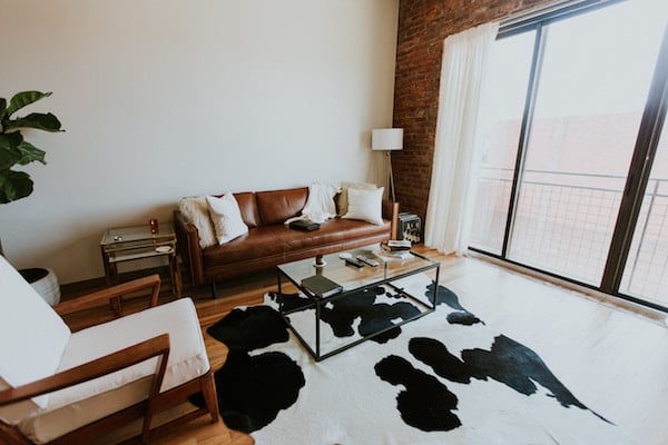 Living room of an apartment with a cow-spotted rug
